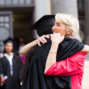 Common Mistakes Parents Make When Saving for College College graduate hugging her mother