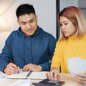 Tips for Americans Struggling to Pay Bills during the Coronavirus Crisis Couple paying bills